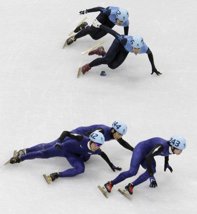 South Korea Jung-Su Lee, bottom right, leads the pack as South Korea's Ho-Suk Lee, bottom left, and South Korea's Si-Bak Sung, bottom center, crash out, during the men's 1500m finals short track skating competition at the Vancouver 2010 Olympics in Vancouver, British Columbia, Saturday, Feb. 13, 2010. (J. Ake / Associated Press)