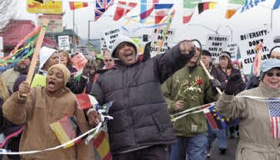 
Tracey Moore, left, and Ron Padmore, center,  march at a diversity rally Sunday in Longview, Wash. Associated Press
 (Associated Press / The Spokesman-Review)