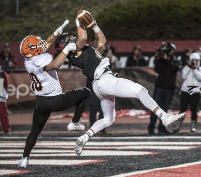 Eastern Washington wide receiver Cooper Kupp tries to haul in a  pass against Idaho State’s Taison Manu. (Dan Pelle / The Spokesman-Review)