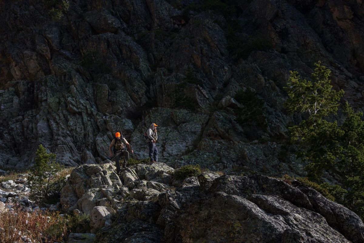 Pete Mumford and Taylor Glenn return from a fifth-class climbing excursion last month while in pursuit of a mountain goat high in Cascade Canyon. Glenn, an experienced climber, likened the challenging effort to “mountaineering with a rifle.” (Ryan Dorgan/News&Guide)