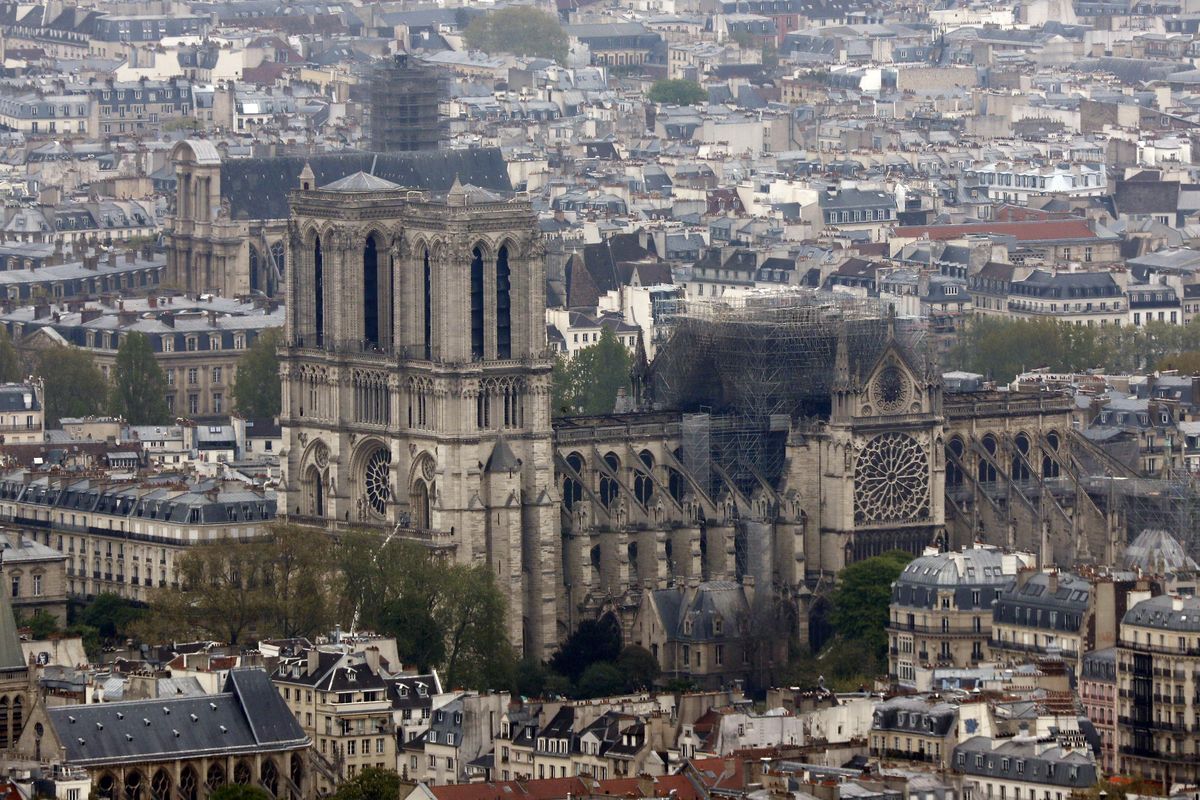 Notre Dame cathedral is pictured from the top of the Montparnasse tower, Tuesday April 16, 2019 in Paris. Firefighters declared success Tuesday morning in an over 12-hour battle to extinguish an inferno engulfing Paris