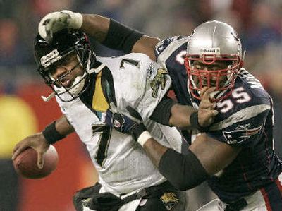 
Willie McGinest drops Byron Leftwich for one of his playoff-record 4½ sacks. 
 (Associated Press / The Spokesman-Review)