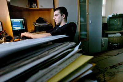 
Max Zaydes, a senior at Fair Lawn High School in Fair Lawn, N.J., stays up late, usually text messaging friends, listening to music and watching TV in his bedroom. He also does his school work late into the evening. Here, he text messages with a few friends while listening to music.
 (Knight Ridder / The Spokesman-Review)