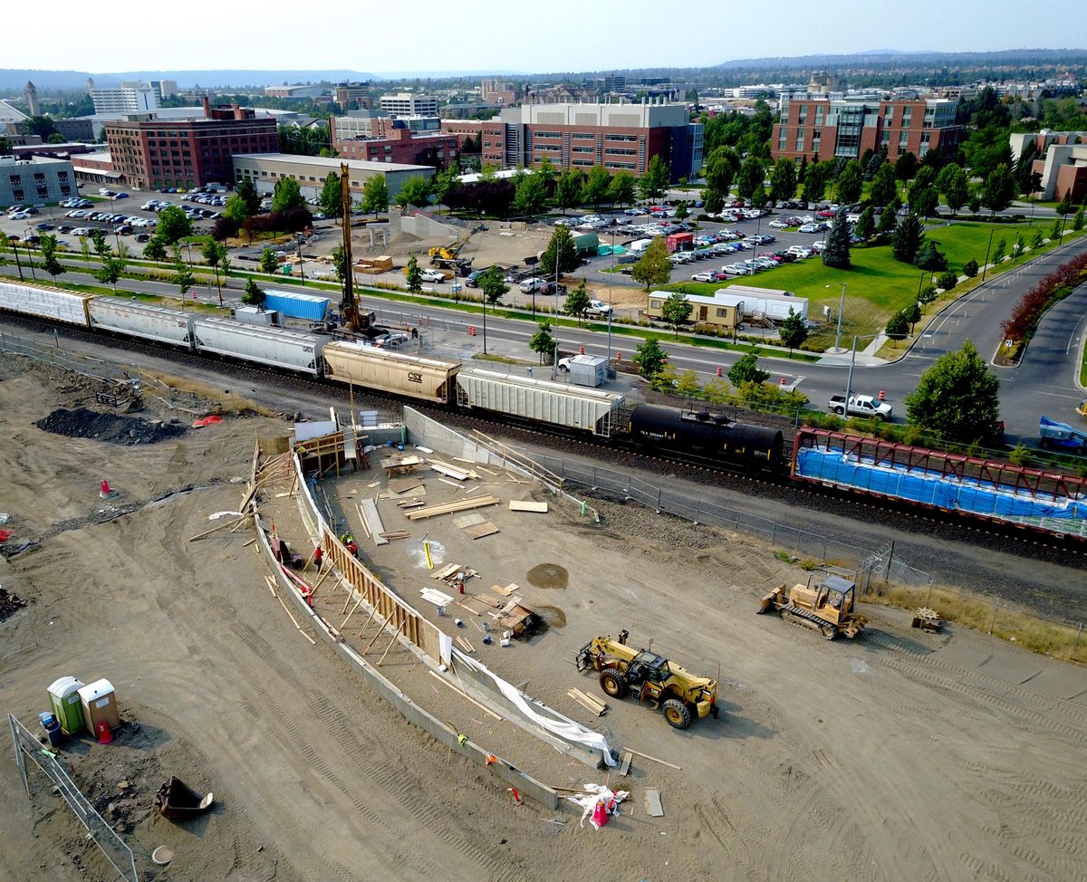 The ramp to the future pedestrian bridge takes shape on Tuesday on the south side of the railroad tracks across from the University District. The corresponding ramp on the other side is also under construction. (Jesse Tinsley / The Spokesman-Review)