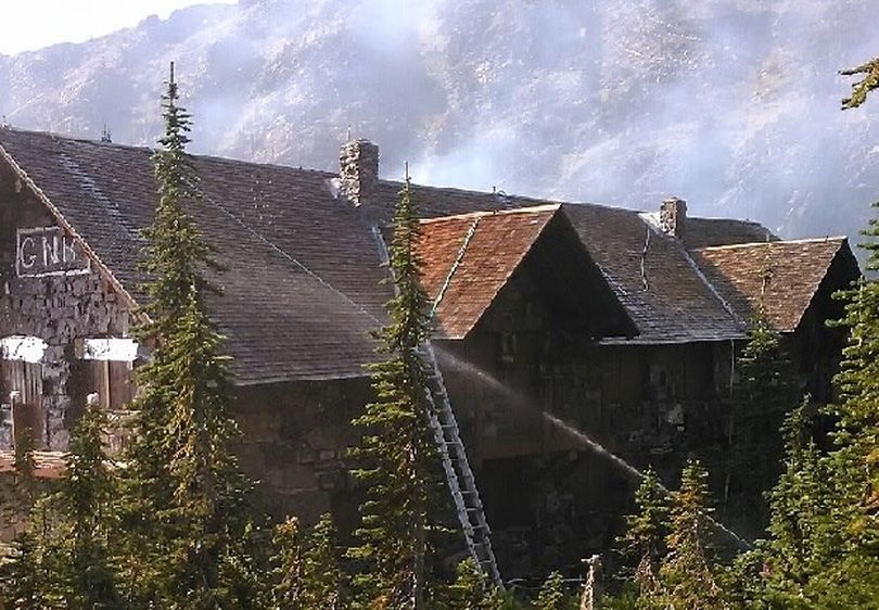 Firefighters work to save the 103-year-old Sperry Chalet from a wildfire in Glacier National Park on Aug. 27.  On Aug. 30, despite their efforts, the main structured caught fire and burned. (National Park Service)