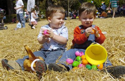 
Norman Hartley, 1, left, watches Roy Troxell, 2, open his candy filled egg Saturday as they participate in the World's Largest Easter Egg Hunt in Stone Mountain, Ga. 
 (Associated Press / The Spokesman-Review)