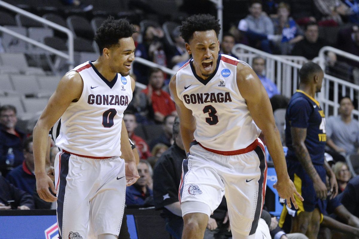 Gonzaga guard Silas Melson, left,  helps forward Johnathan Williams  celebrate a basket  against West Virginia in the first half of their NCAA Sweet 16 game, March 23, 2017, in San Jose, California. (Dan Pelle / The Spokesman-Review)