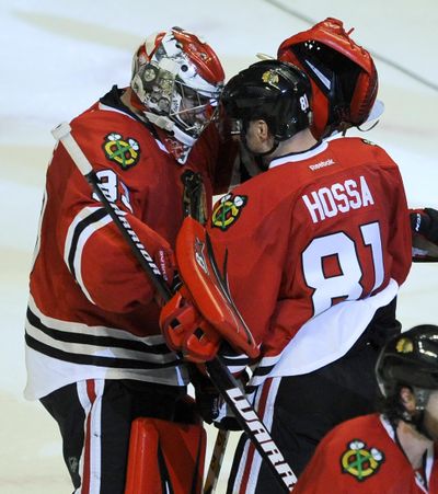 Chicago Blackhawks' Marian Hossa celebrates with teammates after scoring a goal in overtime against the Dallas Stars. (Paul Beaty / Associated Press)