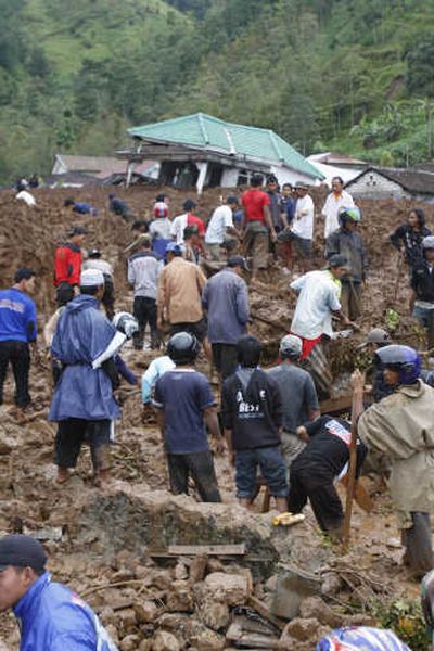 
Rescuers search for landslide victims in Tawangmangu, Central Java, Indonesia, on Wednesday. Associated Press
 (Associated Press / The Spokesman-Review)
