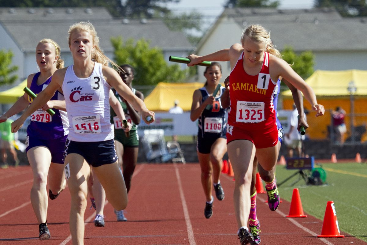 Mt. Spokane’s Ashlee Pedersen, left, holds off hard-charging Ellie Heiden of Kamiakin at the finish of the 3A 800 relay on the final day of the state track championships. (Patrick Hagerty)