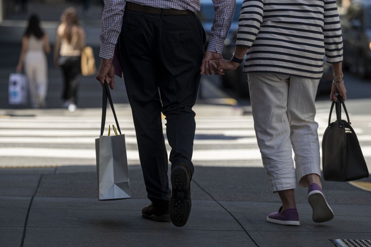 A pedestrian carries a shopping bag in San Francisco, California, on May 18, 2022.  (David Paul Morris/Bloomberg)