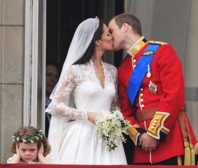 Just about all eyes – including the man behind the curtain (look closely) – were on Kate and William during the big kiss. But not bridesmaid Grace van Cutsem, 3. (Associated Press)