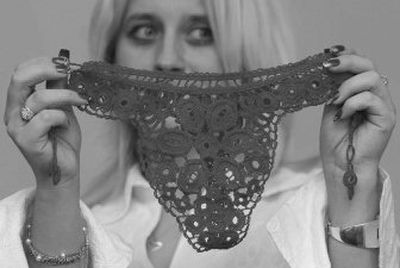 
Malgorzata Stanaszek holds up a hand-stitched lace thong in the village of Istebna, near Koniakow, Poland. 
 (Associated Press / The Spokesman-Review)