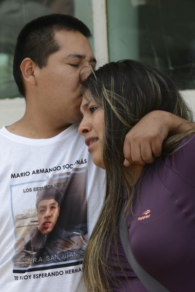 Relatives of Mario Armando Toconas, crew member of the missing ARA San Juan submarine, hug outside the navy base in Mar del Plata, Argentina, Friday, Dec. 1, 2017. (Marina Devo / Associated Press)