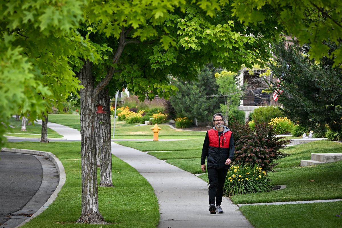 Dan Pinkston walks through the Kendall Yards Neighborhood on Monday, part of his project to walk every street in Spokane, which he is close to completing. He uses an app on his phone to track his progress and encourages others to join him. Pinkston calls himself an urban hiker and has tried to hike many cities, big and small, around the world. (Jesse Tinsley/THE SPOKESMAN-REVIEW)