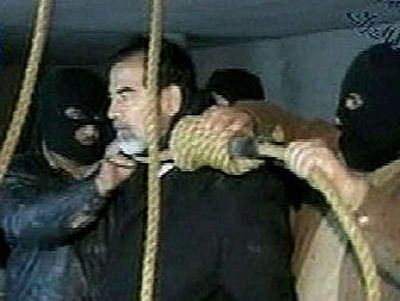 
Saddam meets his end: This image released by Iraqi state television shows Saddam Hussein's guards placing a noose around the deposed leader's neck moments before his execution Saturday morning. 
 (Associated Press photos / The Spokesman-Review)