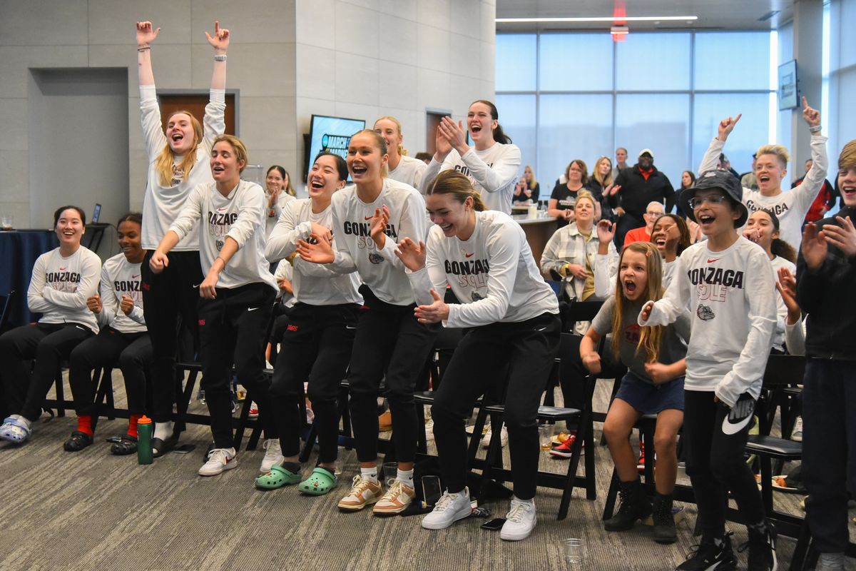 The Gonzaga women’s basketball team leaps to their feet as they see their team appear on the big screen TV with their seeding, location and opponent on Selection Sunday, Mar. 12, 2023 at Gonzaga University.  (Jesse Tinsley/The Spokesman-Review)