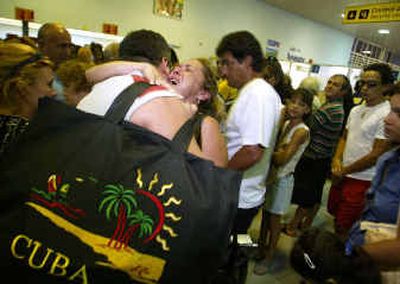 
A woman bids farewell to her relatives at the Jose Marti International Airport on Tuesday in Havana, Cuba. Under new U.S. regulations taking effect today, the Cuban-American can only return to his homeland once every three years.
 (Associated Press / The Spokesman-Review)