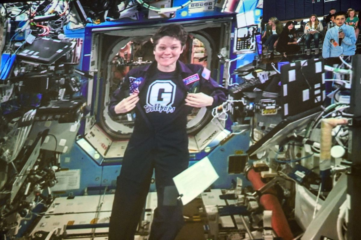 Astronaut Anne McClain displays her Gonzaga Prep Bullpups T-shirt as she participates in an Earth-to-Space video downlink to a gathering of city-wide students at at Gonzaga Prep in this May 2019 photo.   (DAN PELLE)