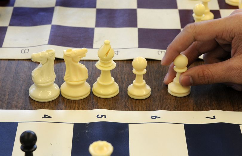 Captured chess pieces won by David Tran of Rogers High School sit off the board  March 5. (Dan Pelle)
