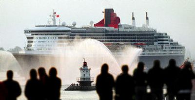 
The Queen Mary 2, the world's largest luxury liner, dwarfs the Spring Point Light as it glides into Portland Harbor in Portland, Maine. The Queen Mary 2 stretches nearly four football fields in length. 
 (The Spokesman-Review)