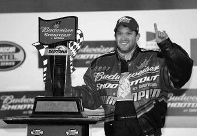 
Tony Stewart stands by his first-place trophy after winning the Budweiser Shootout at Daytona International Speedway. 
 (Associated Press / The Spokesman-Review)