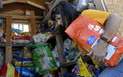 
Ami Gibson of Concerned People for Animals loads donated food into the Rathdrum Pet Food Bank. 
 (Kathy Plonka / The Spokesman-Review)