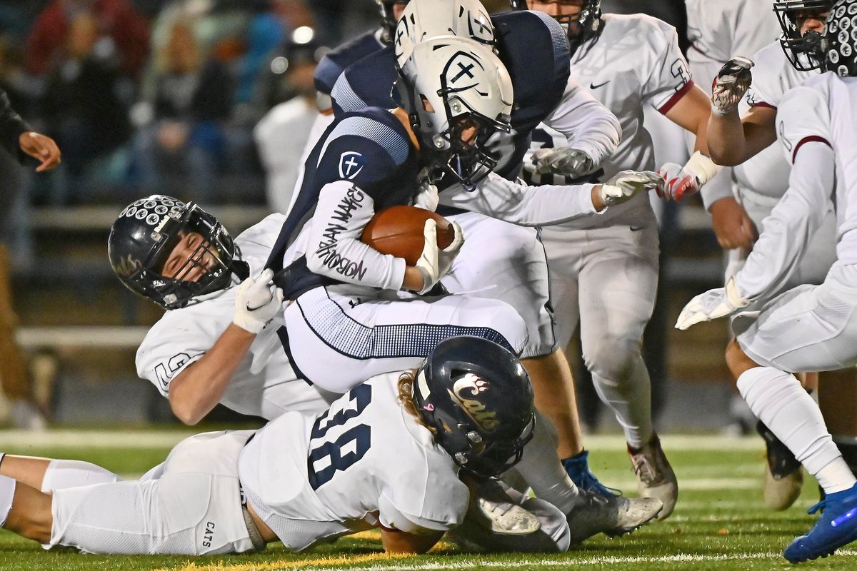 Gonzaga Prep Bullpups running back Lilomaiva Mikaele (23) is caught from behind by Mt Spokane Wildcats linebacker Daniel Schupp (42) during a high school football game at Bullpup Stadium on Friday, Oct 29, 2021 in Spokane WA.   (James Snook/For The Spokesman-Review)