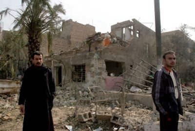 
Iraqis stand in front of a house heavily damagedTuesday in a suicide bomber attack in Baghdad. 
 (Associated Press / The Spokesman-Review)