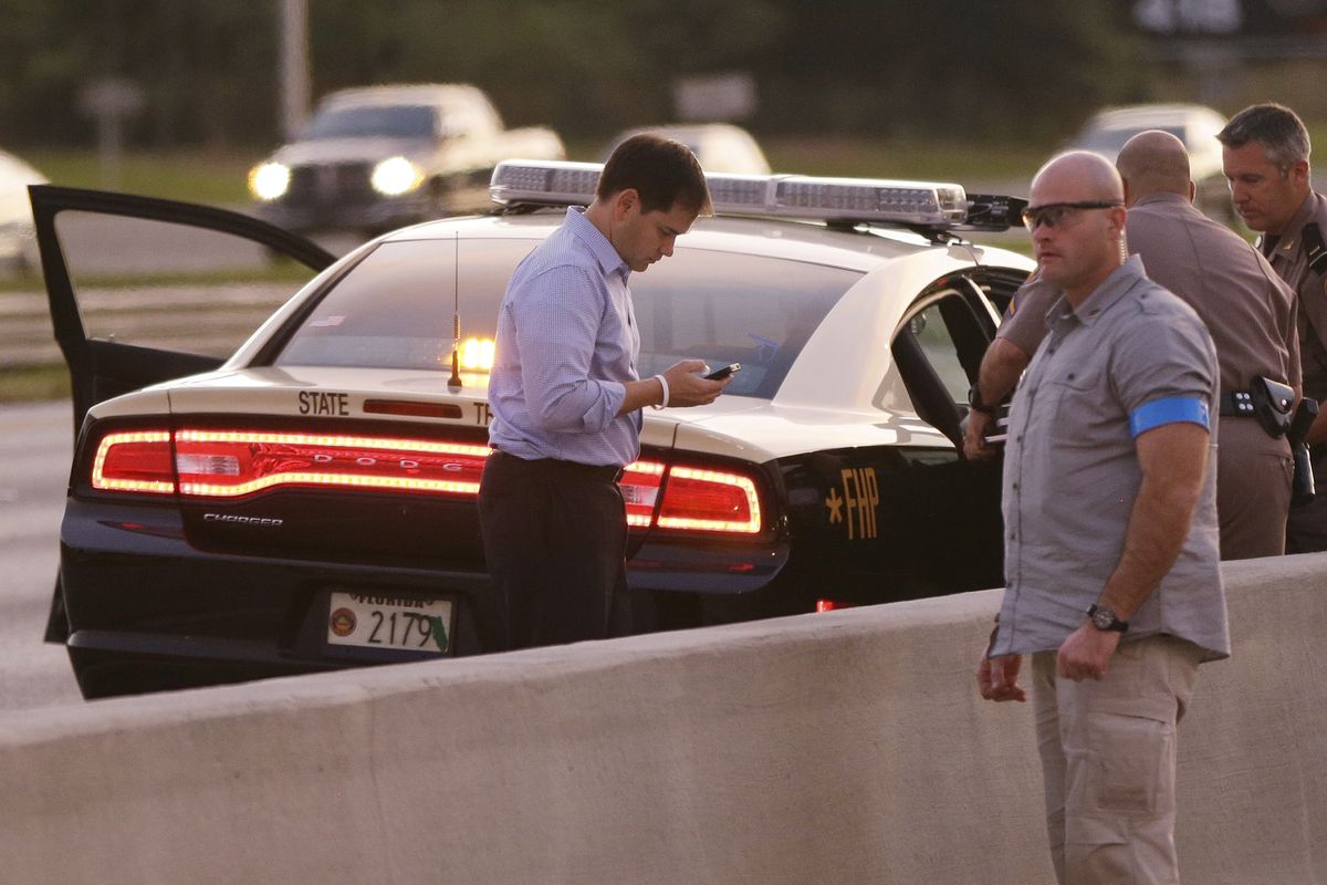 Sen. Marco Rubio, R-Fla., who is traveling with Republican presidential candidate and former Massachusetts Gov. Mitt Romney, uses a phone as he stands alongside Interstate 4 in Lakewood Crest, Fla., Saturday, Oct. 27, 2012 after the motorcade was stopped. The 12-year-old daughter of Sen. Rubio had been airlifted to a hospital after a Saturday motor vehicle accident. A Rubio spokesman reports that the girl is in stable condition. (Charles Dharapak / Associated Press)