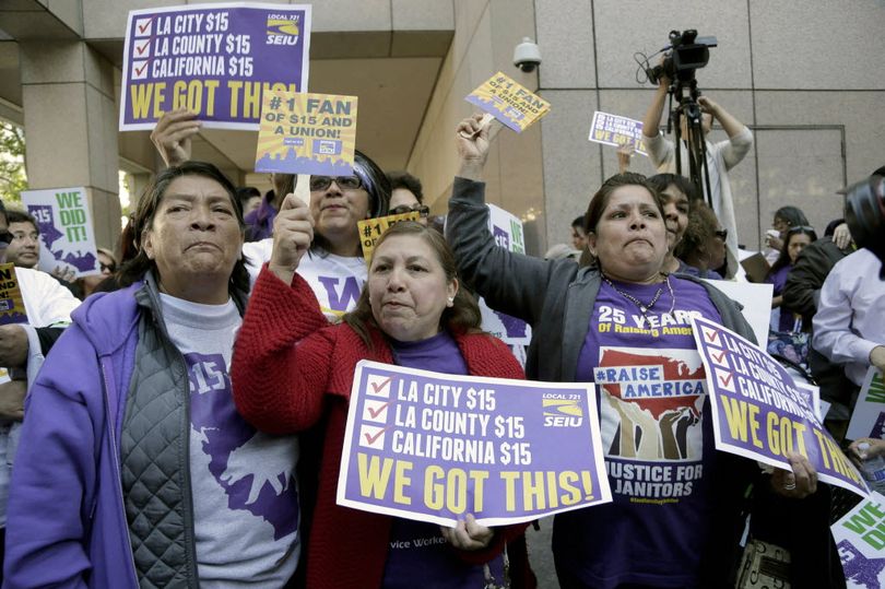 Workers rally outside the Ronald Reagan State Building in Los Angeles after California's Gov. Jerry Brown signed a bill creating highest statewide minimum wage at $15 an hour by 2022 in Los Angeles, Monday, April 4, 2016. California and New York acted Monday to gradually push their statewide minimum wages to $15 an hour, the highest level in the nation. (AP Photo/Nick Ut) 