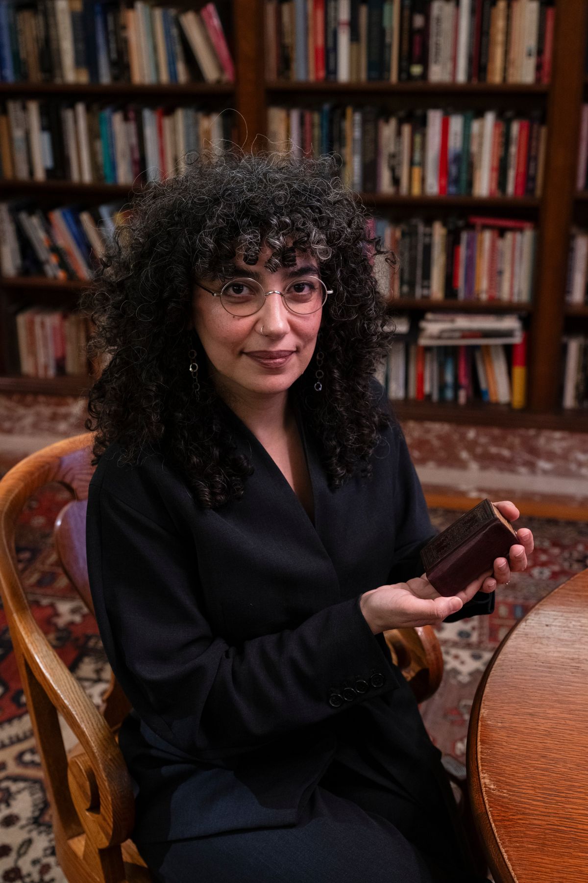 Hiba Abid, curator for Middle Eastern and Islamic Studies at the New York Public Library, holds the Quran belonging to Arturo Schomburg, the Black writer and historian, that will play a role in New York City Mayor-elect Zohran Mamdani