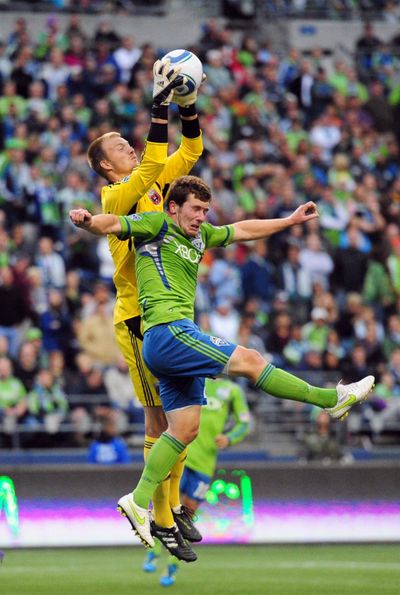 DC United’s Joe Willis stops a scoring attempt by Seattle’s Mike Fucito during the first half Saturday. (Associated Press)