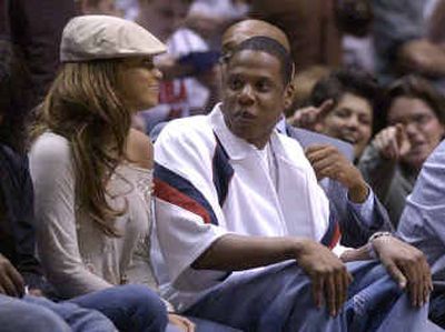 
According to magazine consultant Patti Wood, music artists Beyonce Knowles, left, and Jay-Z are a pair of fakers when it comes to expressing love with their bodies. Above, the duo sit on the sidelines while watching an NBA playoffs game between the Detroit Pistons and New Jersey Nets last month.
 (File/Associated Press / The Spokesman-Review)