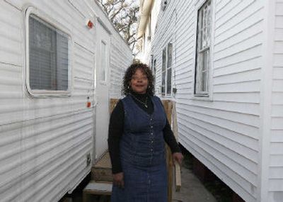 
Joyce Ridgeway stands between her home and her FEMA trailer in New Orleans. Ridgeway's four-family house in the Esplanade Ridge neighborhood of New Orleans was damaged when Katrina hit in August 2005. 
 (Associated Press / The Spokesman-Review)