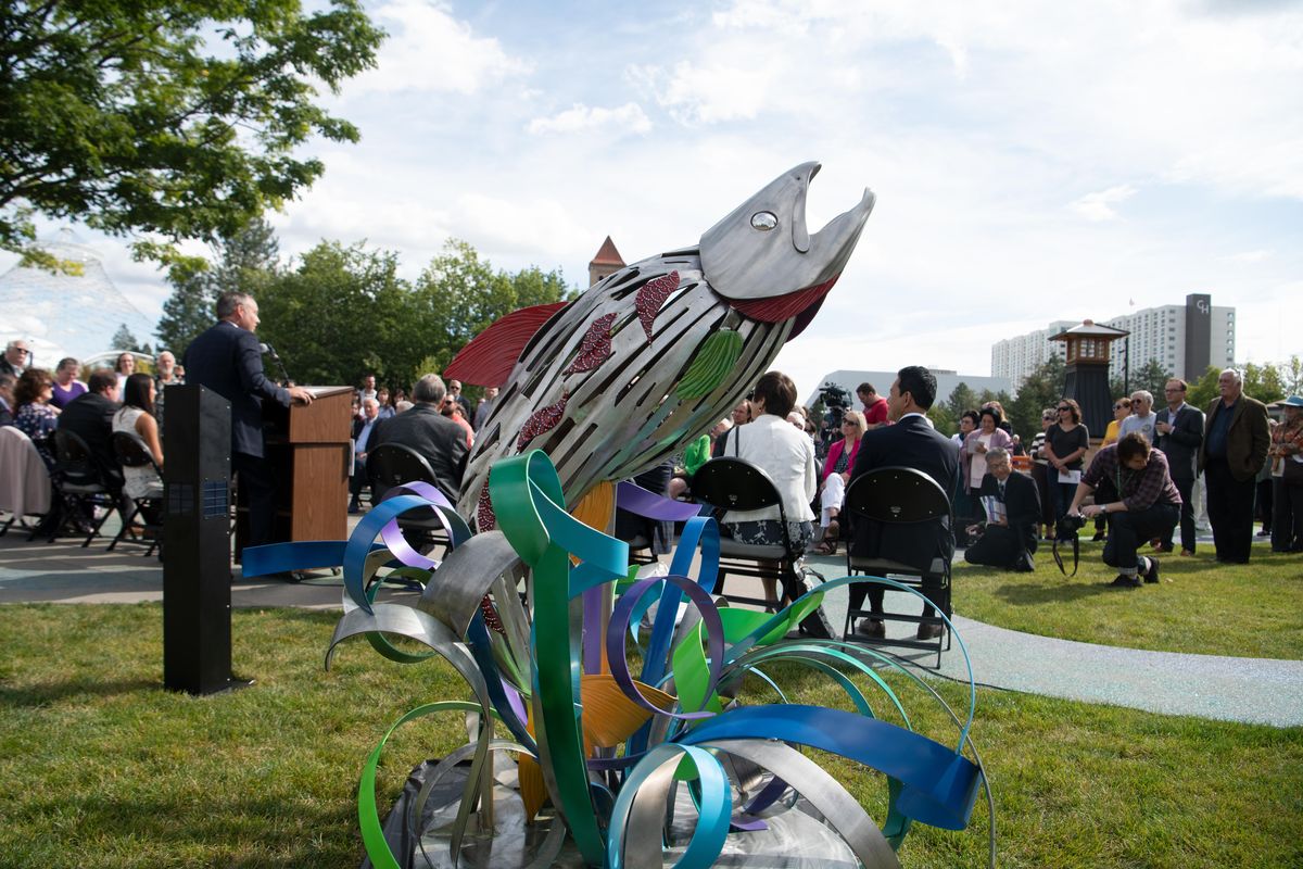 A fish sculpture by Melissa Cole, representing the city’s connection with Native American tribes, sits temporarlily in the new Sister Cities Connections Garden in Riverfront Park Friday, Sept. 13, 2019, in Spokane. A crowd attended the ceremony opening the garden, which included sculptures representing cities in Ireland and Japan. (Jesse Tinsley / The Spokesman-Review)