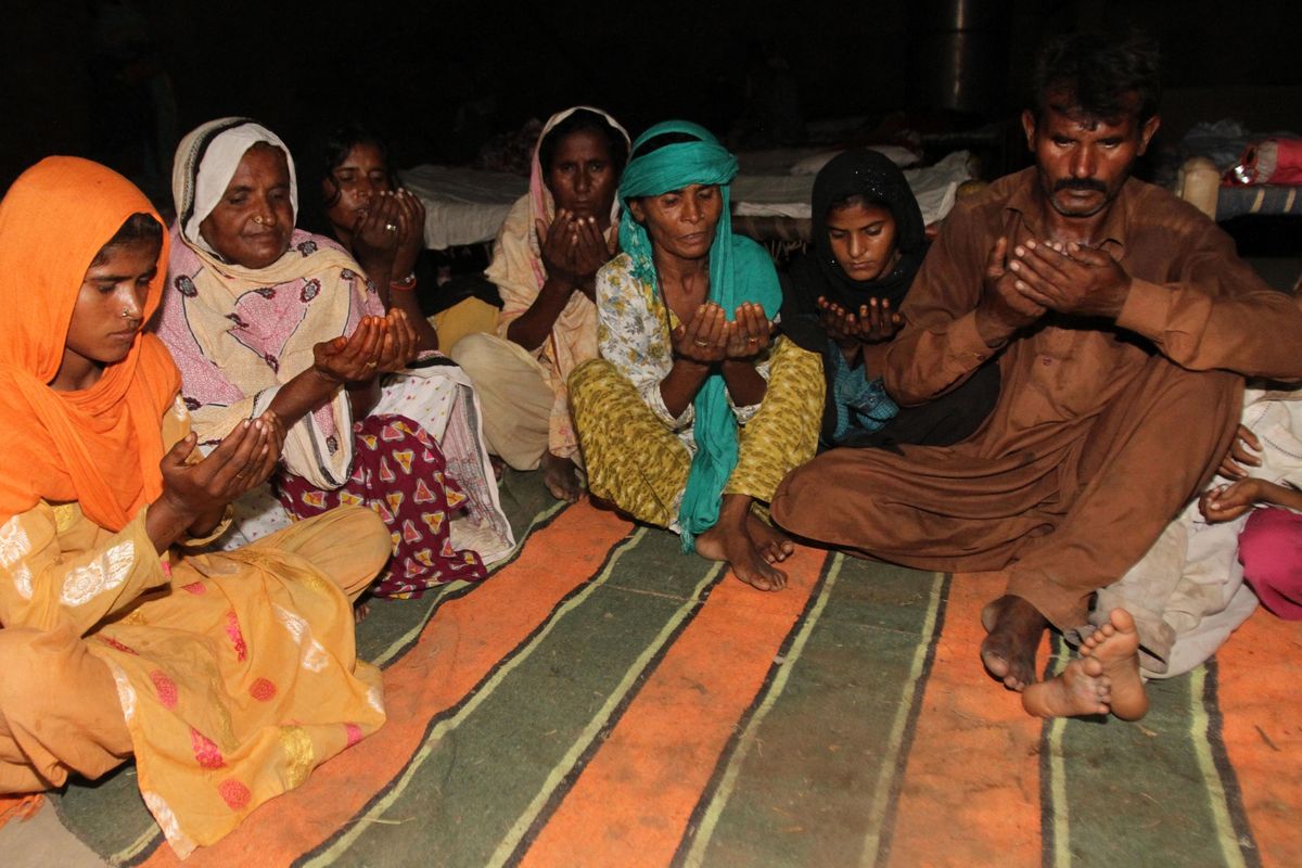 Family members of Khalida Bibi who was hanged, pray for her in Mian Channu, Pakistan, Friday, Sept. 16, 2016. Pakistani police on Thursday arrested the father, husband and brother of Khalida Bibi who was tortured and hanged alongside her alleged boyfriend in a family courtyard, a local police official said. Bibi, a married mother-of-three, and her alleged boyfriend, 21-year-old Mohammad Mukhtar, were murdered in a so-called honor killing, the police official Allah Ditta said. (Asim Tanveer / Associated Press)