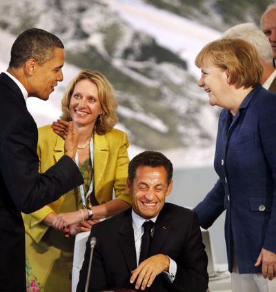 President Barack Obama jokes with French President Nicolas Sarkozy and German Chancellor Angela Merkel, right, before the start of G-8 meetings Wednesday.  (Associated Press / The Spokesman-Review)