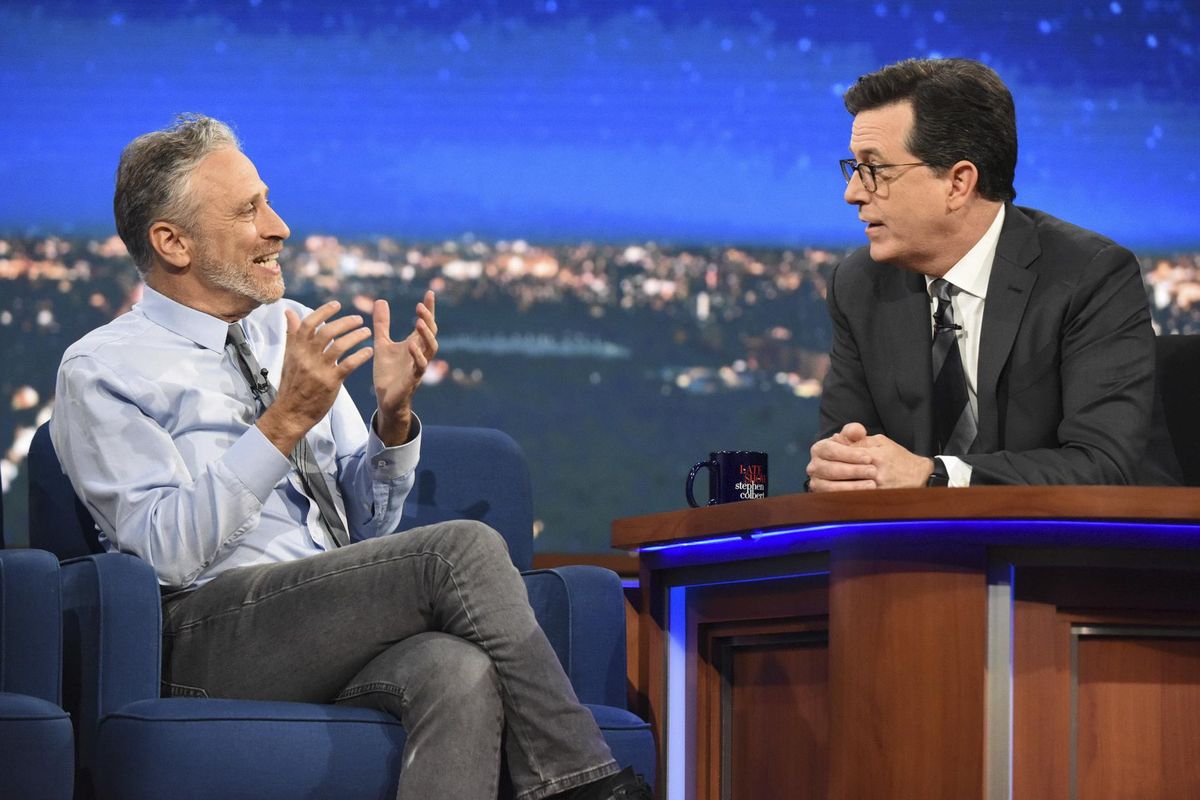 In this photo provided by CBS, guest Jon Stewart , left, speaks with host Stephen Colbert on "The Late Show with Stephen Colbert," during the television show on Tuesday, May 9, 2017, in New York. It was a rare TV reunion Tuesday as Colbert played host to a gang of his fellow Daily Show alums, including Stewart, on a special edition of CBS “The Late Show.” (Scott Kowalchyk / CBS)