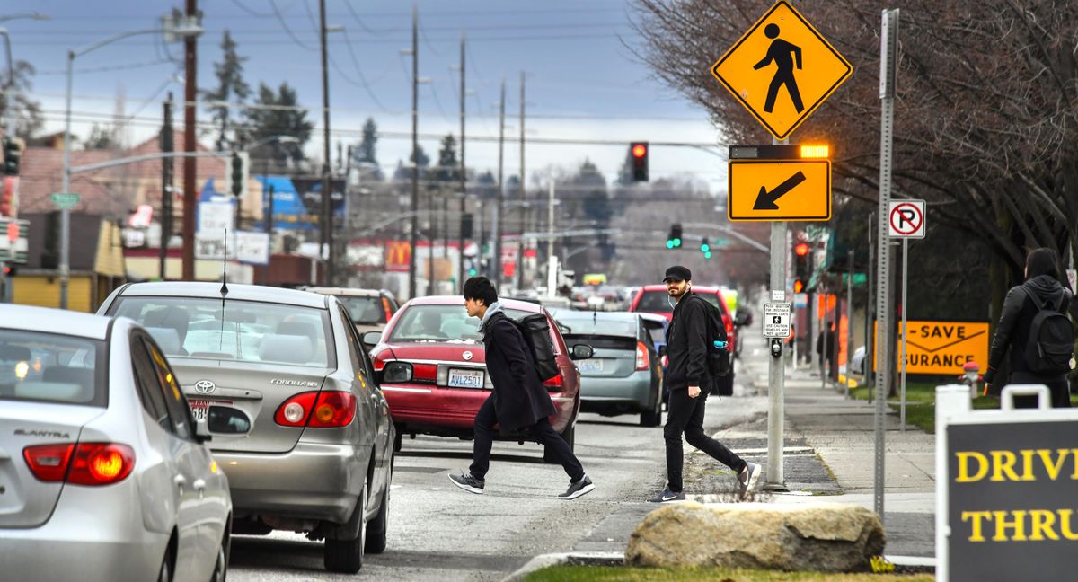 Pedestrians cross Hamilton Street at Desmet Avenue with the help of a HAWK (High-Intensity Activated crossWalK) beacon on April 6 near the Gonzaga University campus. (Dan Pelle / The Spokesman-Review)