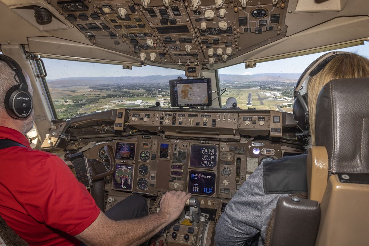 As pilot Joe Duval (left) comes in for a landing at the airport in Yakima the instrument panel at lower left lights up with the words “TOO FAST,” advising Duval to slow the plane down June 7.  (Ellen M. Banner)