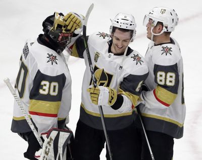 Vegas Golden Knights goalie Malcolm Subban, left, celebrates with defensemen Colin Miller, center, and Nate Schmidt after they defeated the Chicago Blackhawks in an NHL hockey game Friday, Jan. 5, 2018, in Chicago. (Nam Y. Huh / Associated Press)