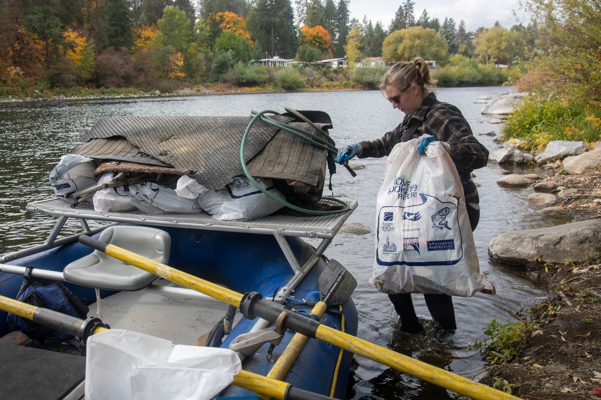 Above: Liv Kindl, of the Spokane Riverkeeper, picks up garbage found along the Spokane River Oct. 12 in Spokane.  (Michael Wright/THE SPOKESMAN-REVIEW)