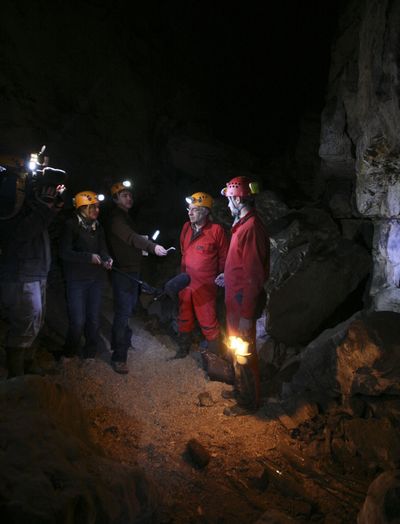 In the photo above, amateur archaeologist Laurent Dujardin, second from right, and photographer Damien Butaye, right, are seen in a quarry last month near Caen, France. The photo at left shows old bottles in a quarry. Associated Press photos (Associated Press photos / The Spokesman-Review)