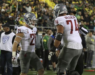 Washington State's Max Borghi, left, and Robert Valencia celebrate a touchdown against Oregon in the second quarter of an NCAA college football game, Saturday, Oct. 26, 2019, in Eugene, Ore. (Chris Pietsch / AP)