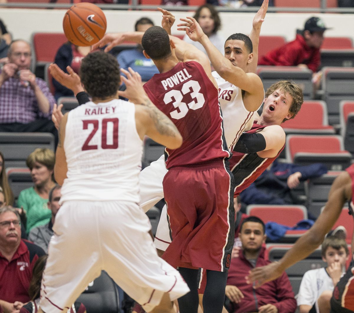 WSU’s Dexter Kernich-Drew passes to Jordan Railey as Stanford’s Dwight Powell and John Gage defend. (Associated Press)