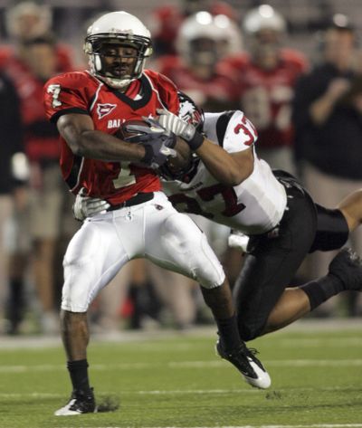 Ball State running back Cory Sykes grinds for yardage.  (Associated Press / The Spokesman-Review)