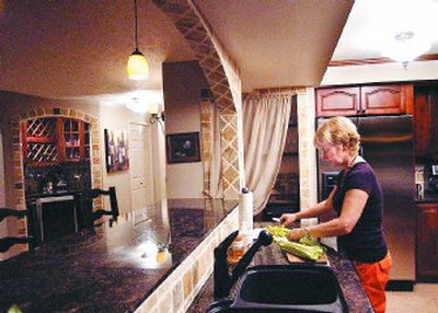 
Wendy Jones chops celery in her kitchen at The Ridge in Spokane. Jones had her condominium totally remodeled. 
 (Liz Kishimoto / The Spokesman-Review)