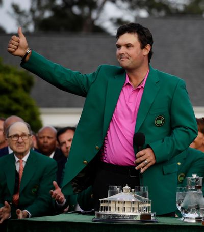 Patrick Reed gives a thumbs up after being presented with the championship trophy after winning the Masters golf tournament Sunday, April 8, 2018, in Augusta, Ga. (Chris Carlson / Associated Press)