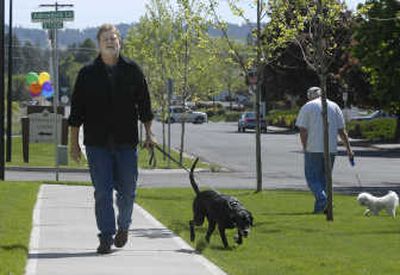 
Don Brush of South Hill Pet Sitting takes Zeke  for a walk. 
 (Dan Pelle / The Spokesman-Review)